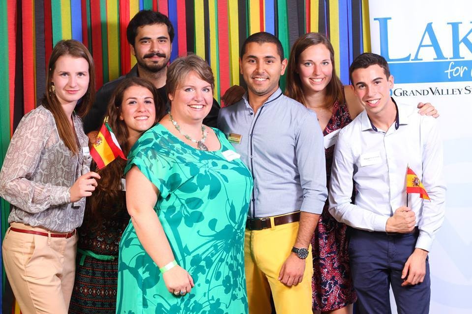 Seven people smiling holding the Spanish flag